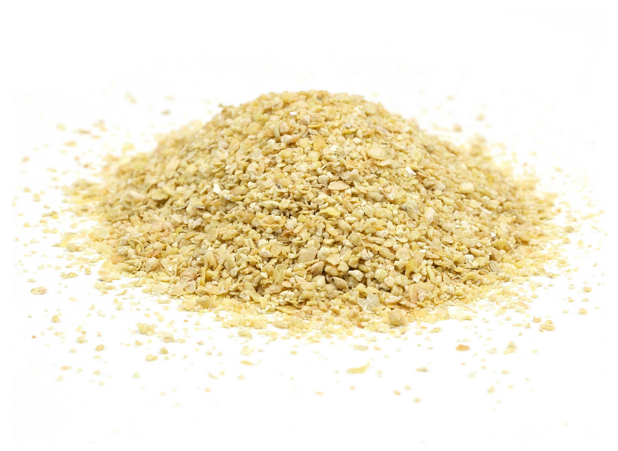 Close up of a small pile of soybean meal on a white background.