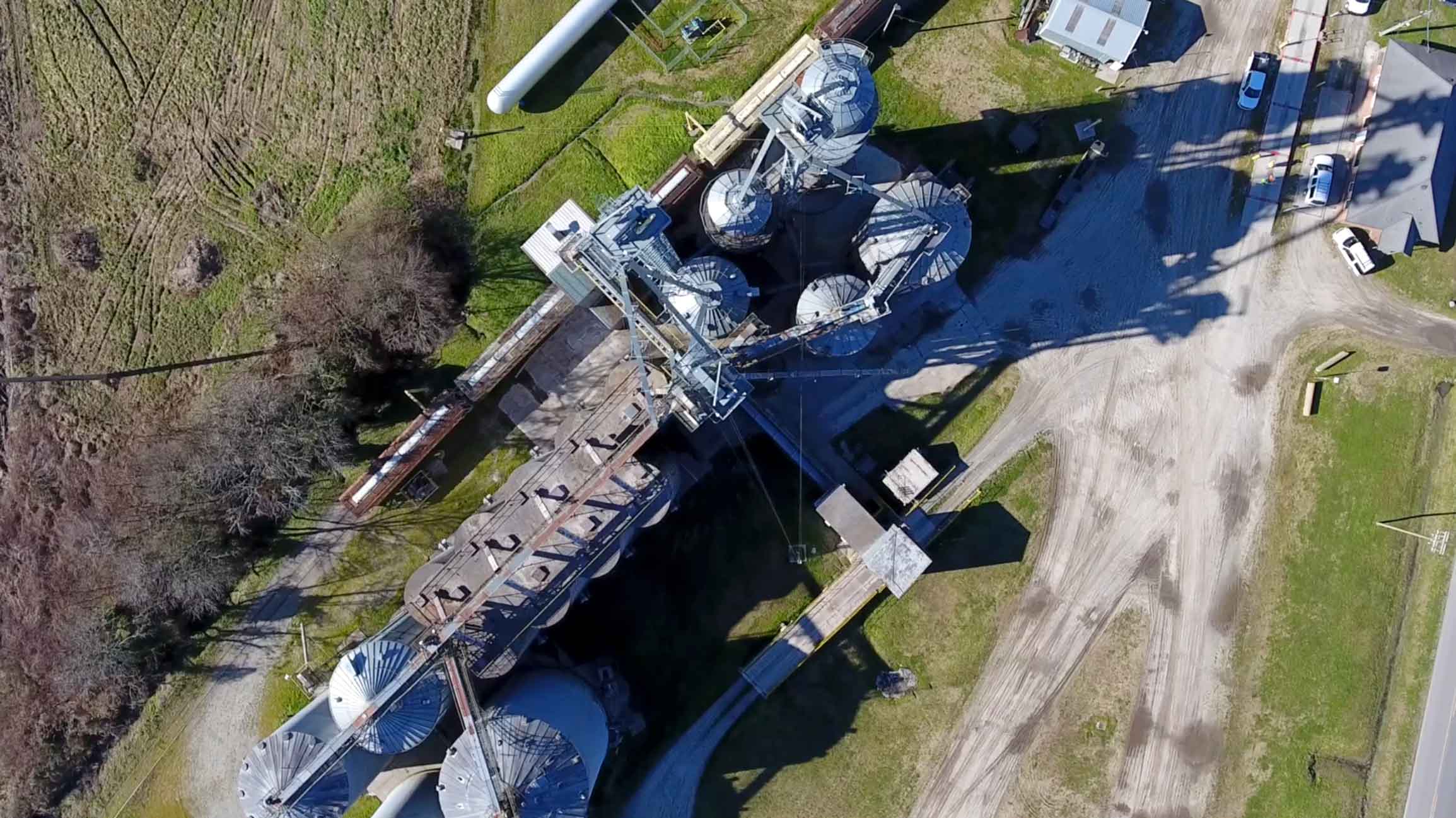 Aerial view of industrial silos and grain elevator.