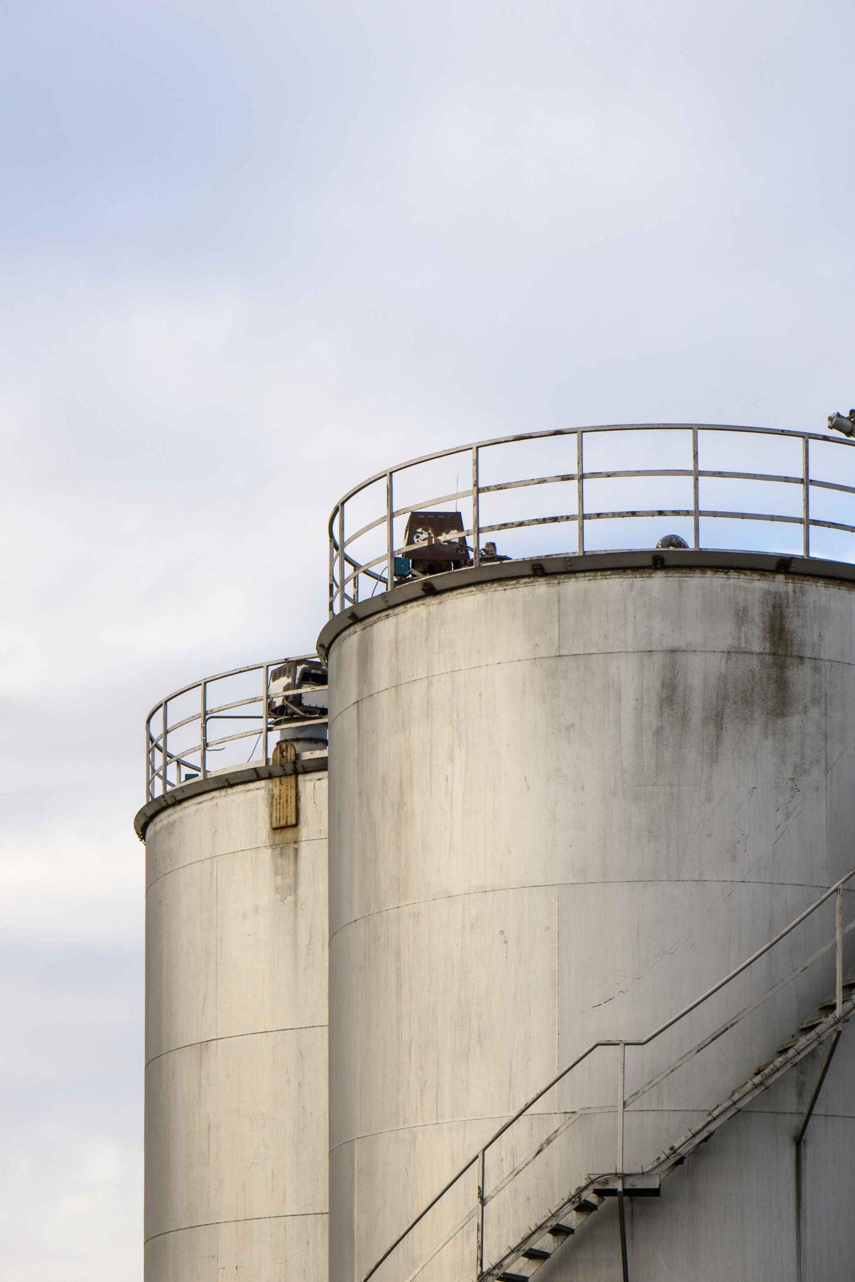 Close up of two industrial grain silos.